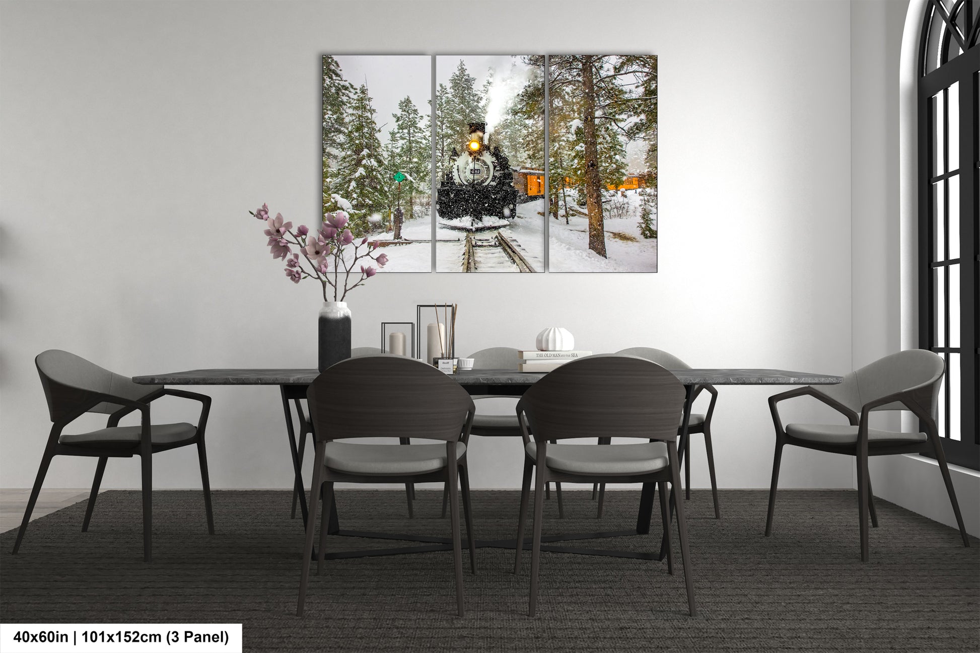 a dining room table with chairs and a painting on the wall