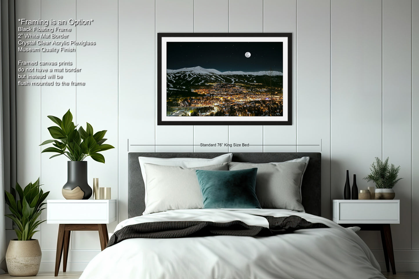 a bedroom with a large bed and a picture hanging on the wall