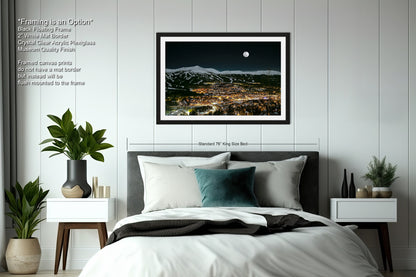 a bedroom with a large bed and a picture hanging on the wall