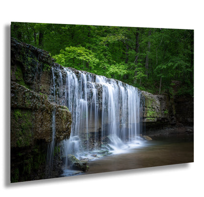 a waterfall in the middle of a forest