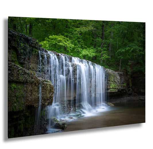 a waterfall in the middle of a forest