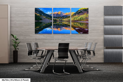 a dining room table with chairs and a painting on the wall