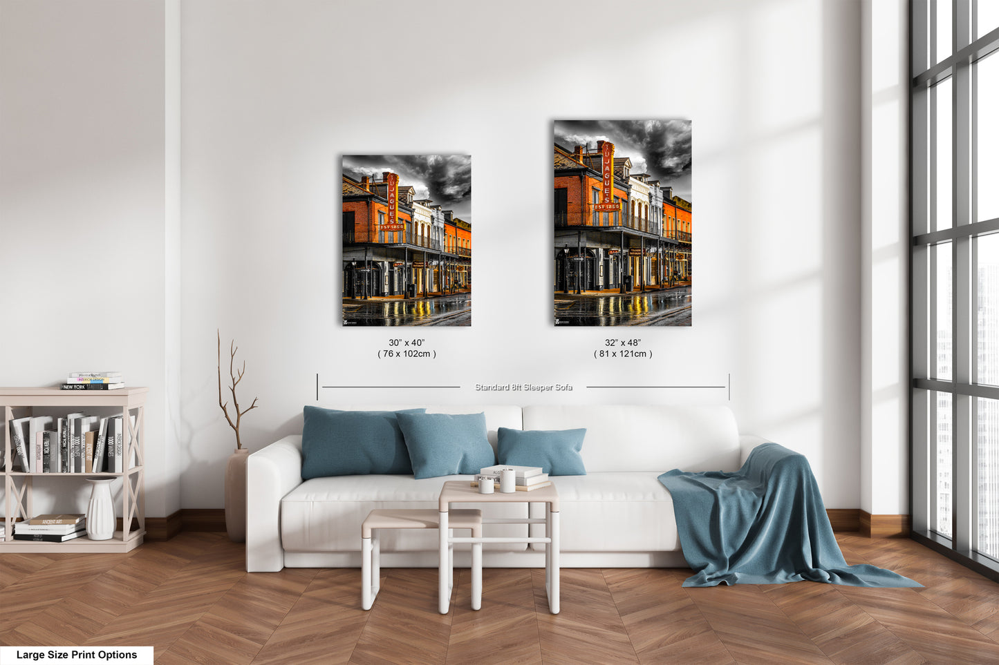 a living room with a white couch and two pictures on the wall