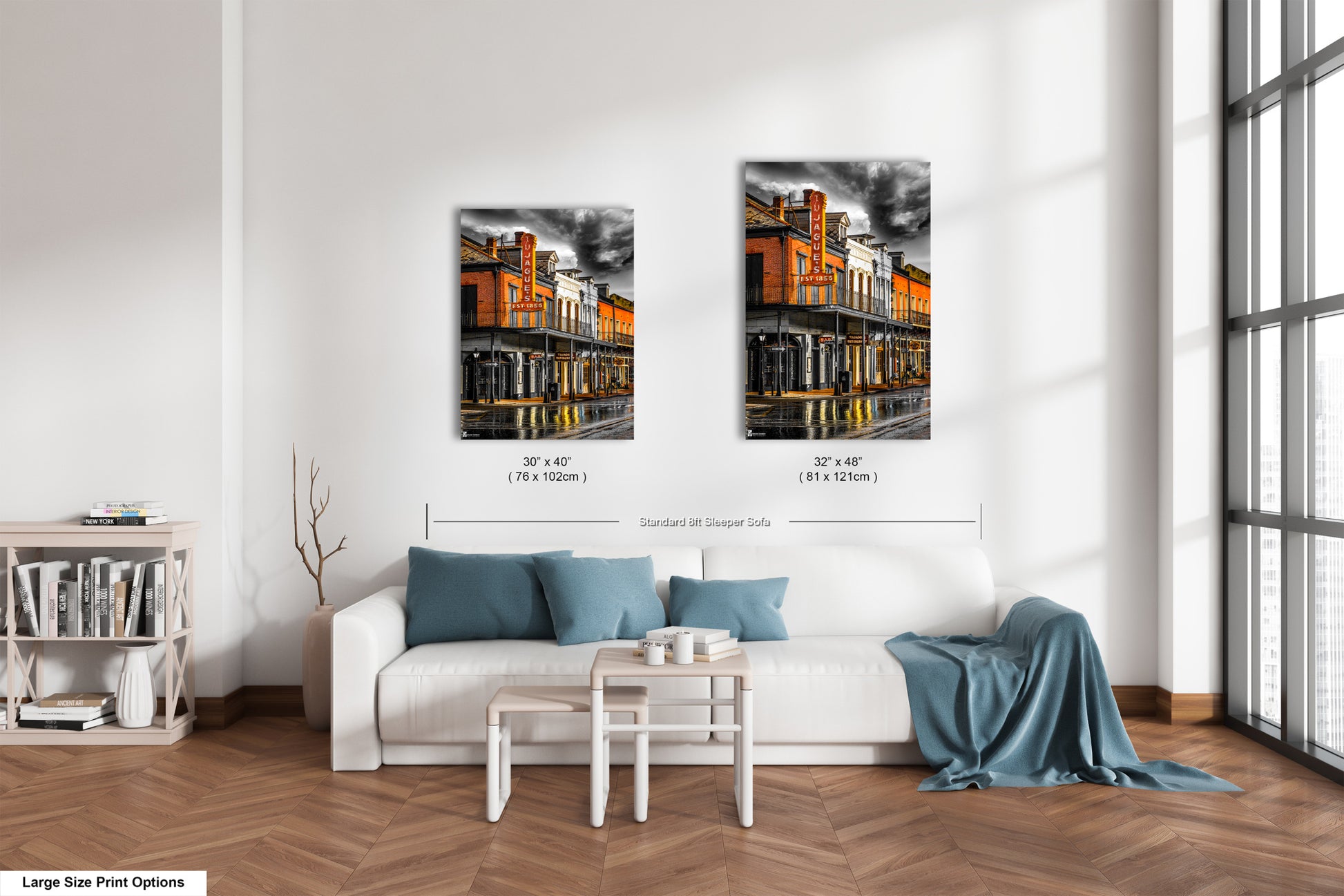 a living room with a white couch and two pictures on the wall