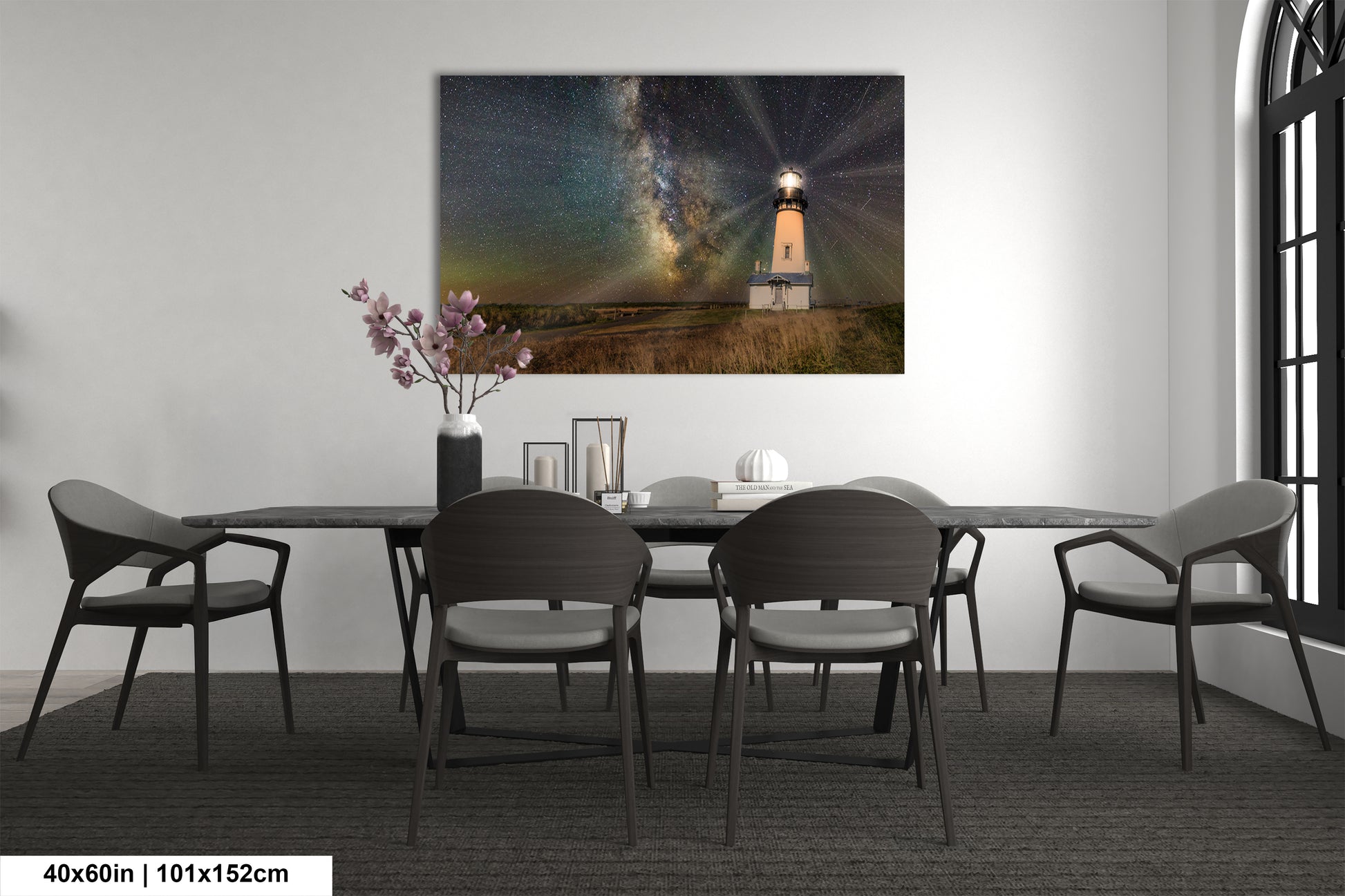 a room with a table and chairs and a painting on the wall