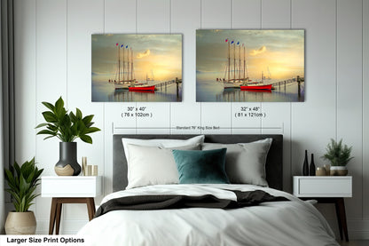 a bedroom with a bed and two paintings on the wall