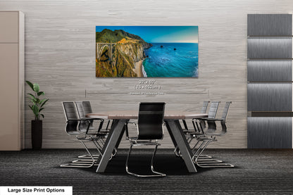 a dining room table with chairs and a painting on the wall