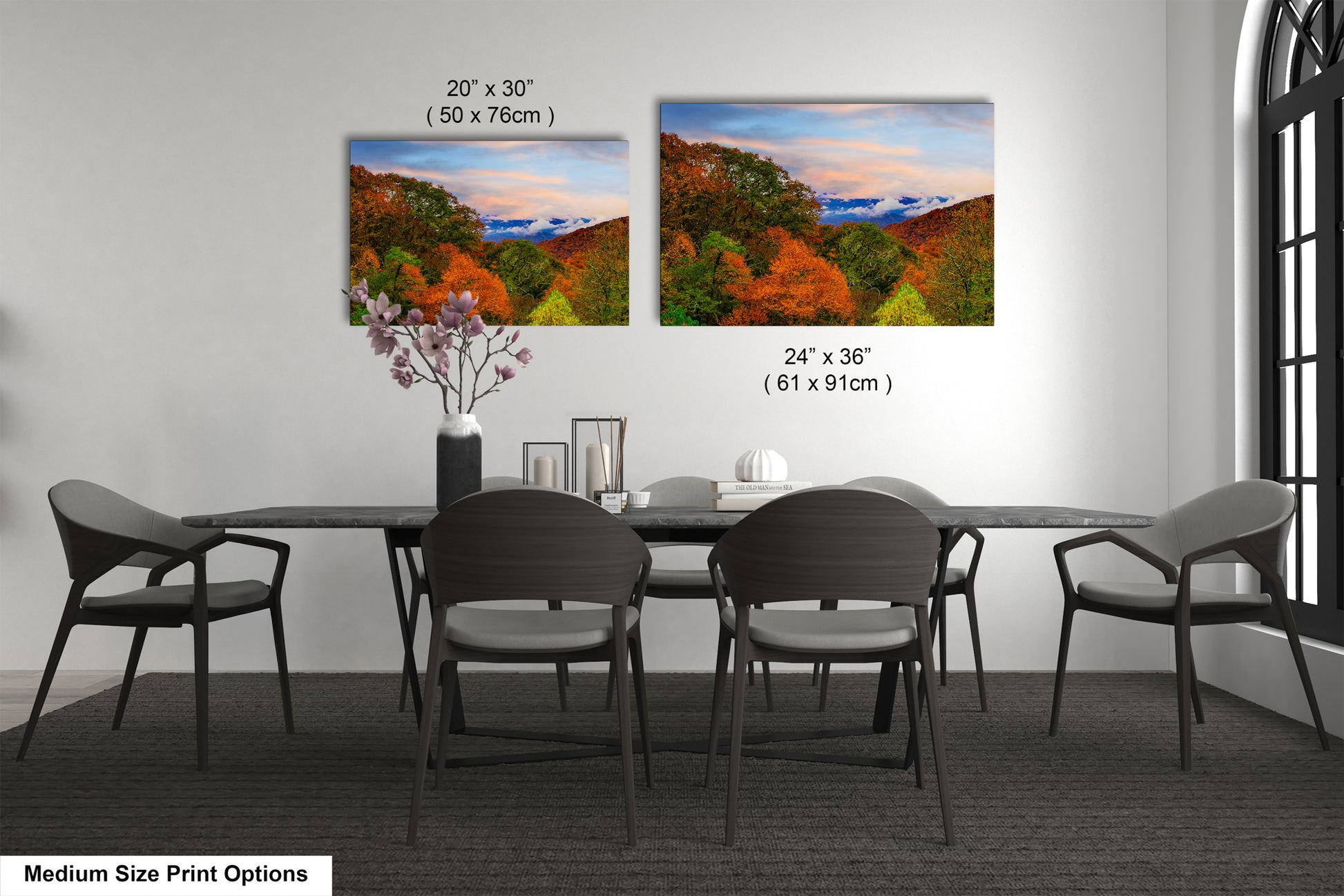 a dining table with four chairs and a vase with flowers