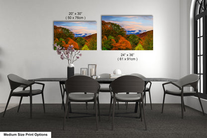 a dining table with four chairs and a vase with flowers