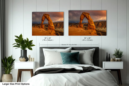a bed with a white comforter and two pictures on the wall