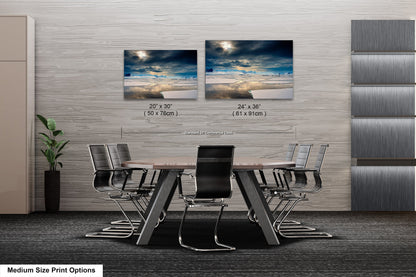 a dining room table with four chairs and two pictures on the wall