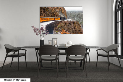 a dining room table with chairs and a painting on the wall