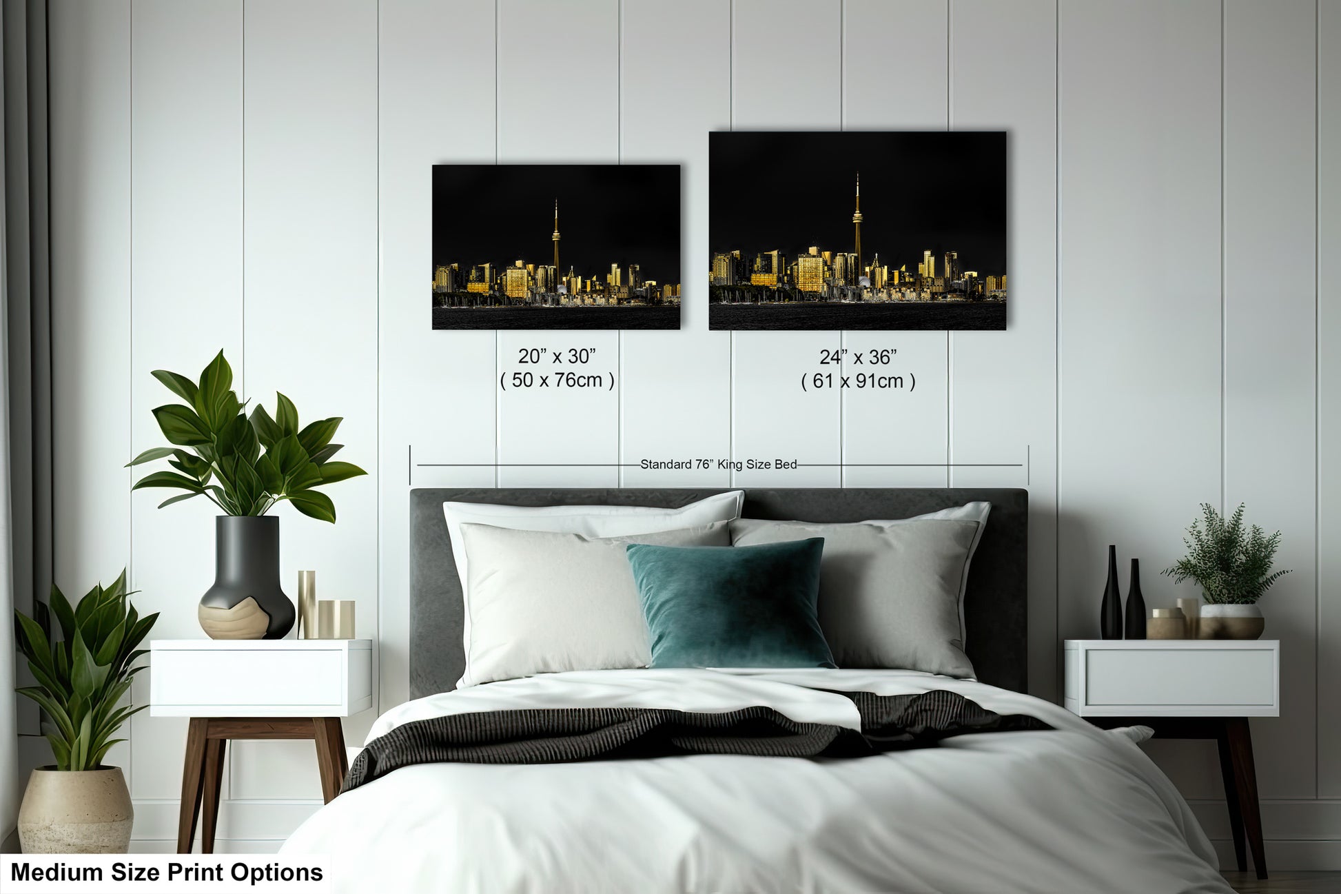 a bed with a white comforter and two pictures on the wall above it