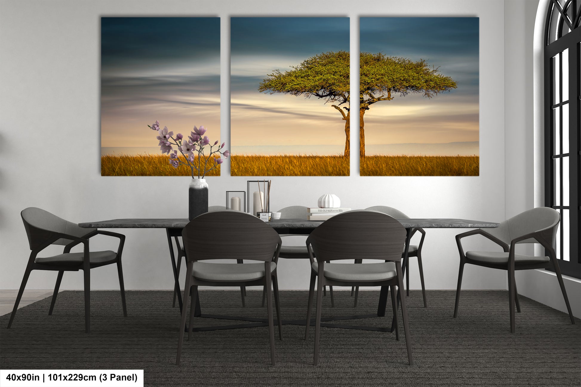 a dining room table with four chairs and a painting on the wall