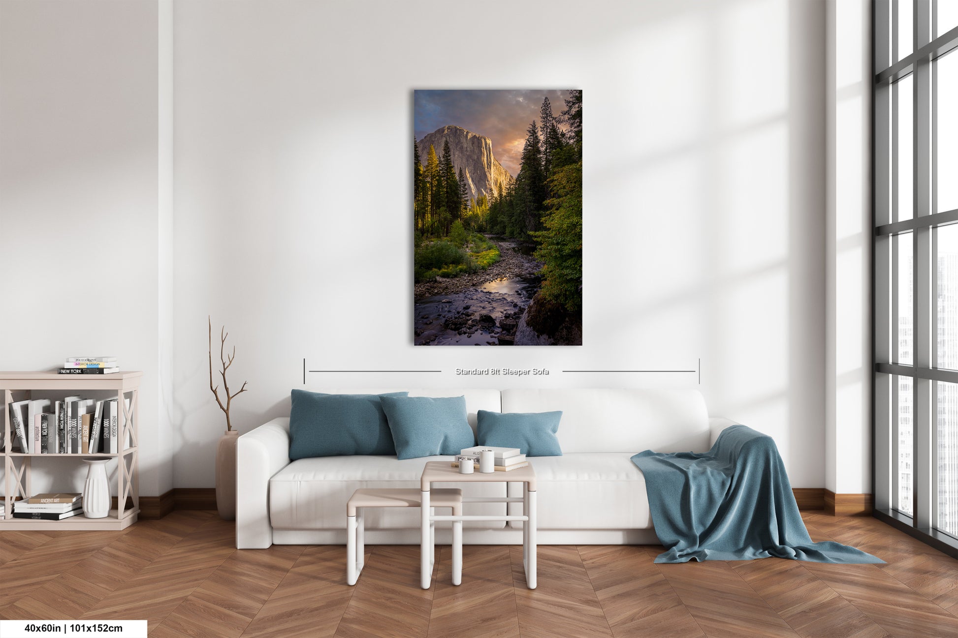 a living room with a white couch and a painting on the wall