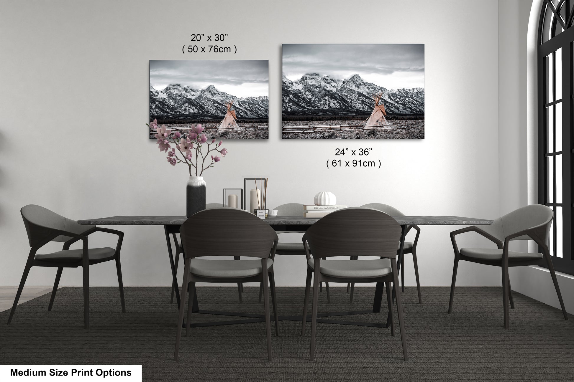a dining table with four chairs and a vase with flowers