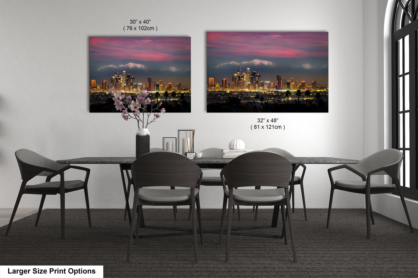 a dining room table with four chairs and a vase with flowers