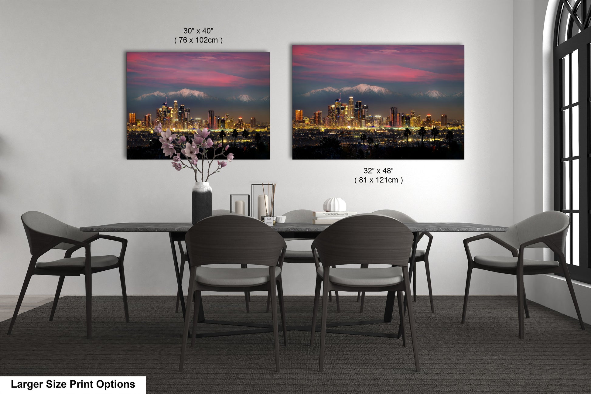 a dining room table with four chairs and a vase with flowers