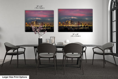 a dining room table with four chairs and a vase with flowers