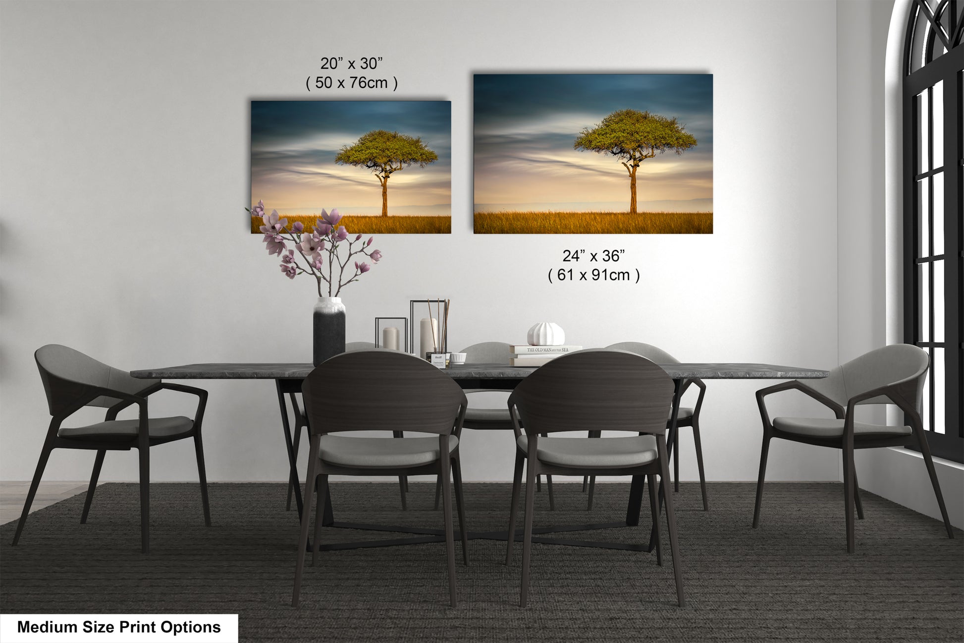a dining table with four chairs and a vase with flowers