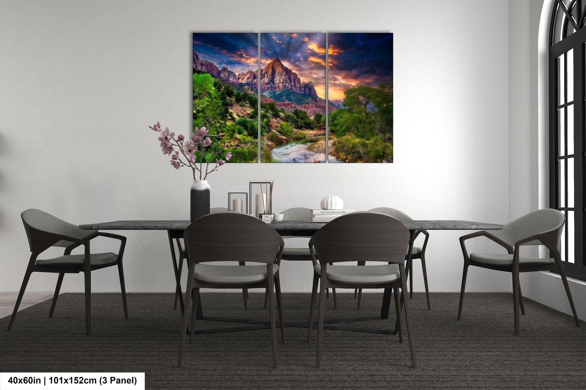 a dining room table with chairs and a painting on the wall