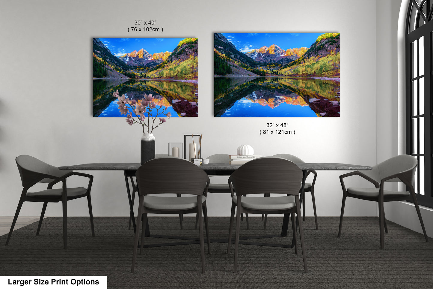a dining room table with four chairs and a painting on the wall