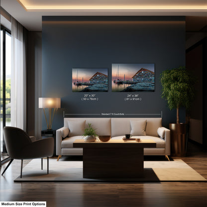 The image is a modern living room with a large window, a white sofa, a coffee table, and two framed pictures of a sunset over a body of water.