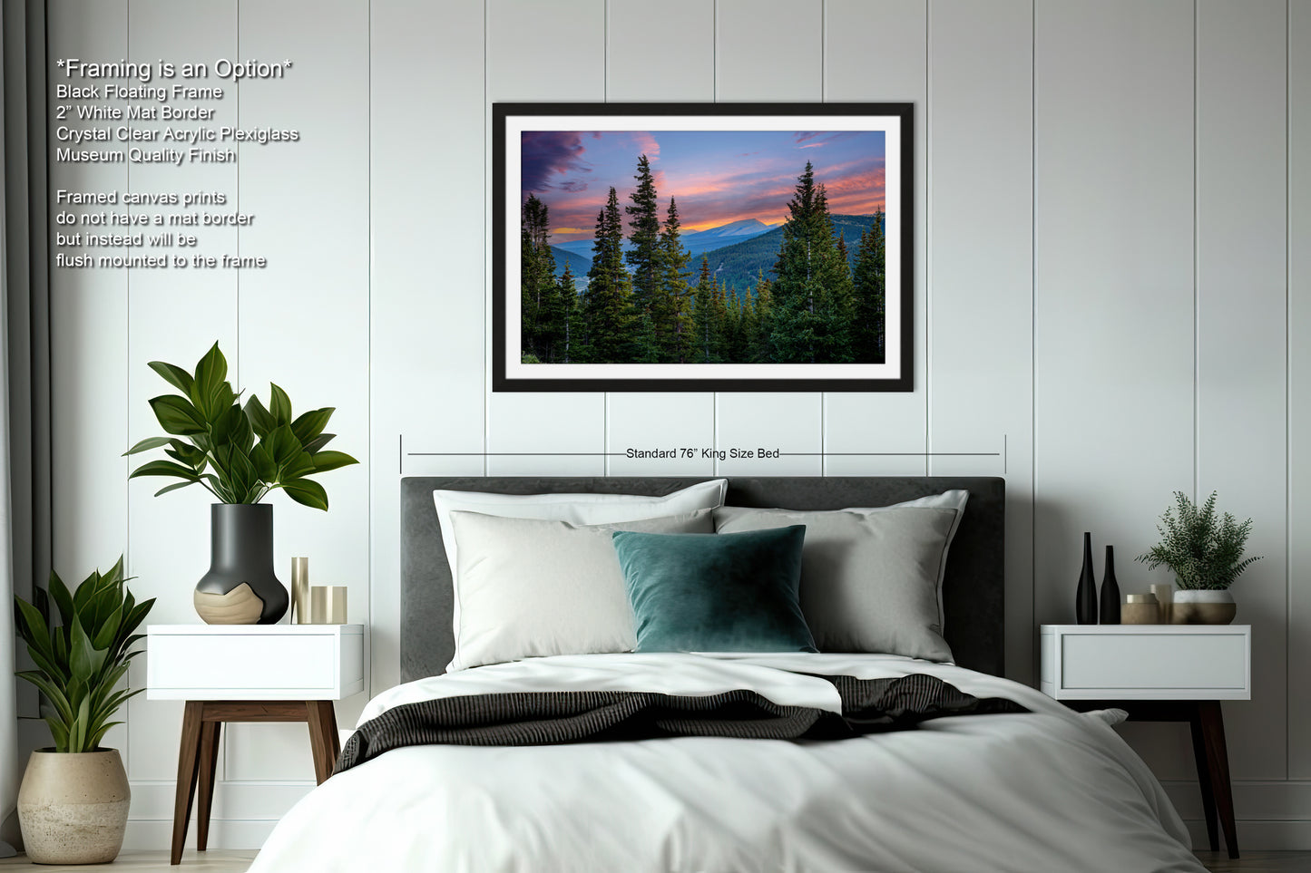a bedroom with a large framed picture of a mountain landscape hanging on the wall above a bed with white bedding and a green throw pillow.