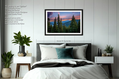 a bedroom with a large framed picture of a mountain landscape hanging on the wall above a bed with white bedding and a green throw pillow.