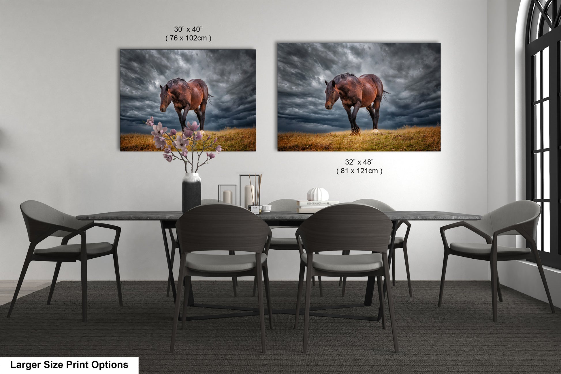 a dining room table with four chairs and two pictures of a horse on the wall