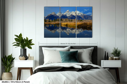 a bed room with a neatly made bed and a painting on the wall