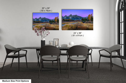 a dining room table with four chairs and a vase of flowers