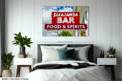 a bed room with a neatly made bed and a poster on the wall