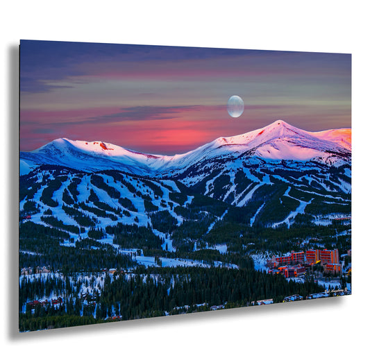 a view of a mountain with a full moon in the sky