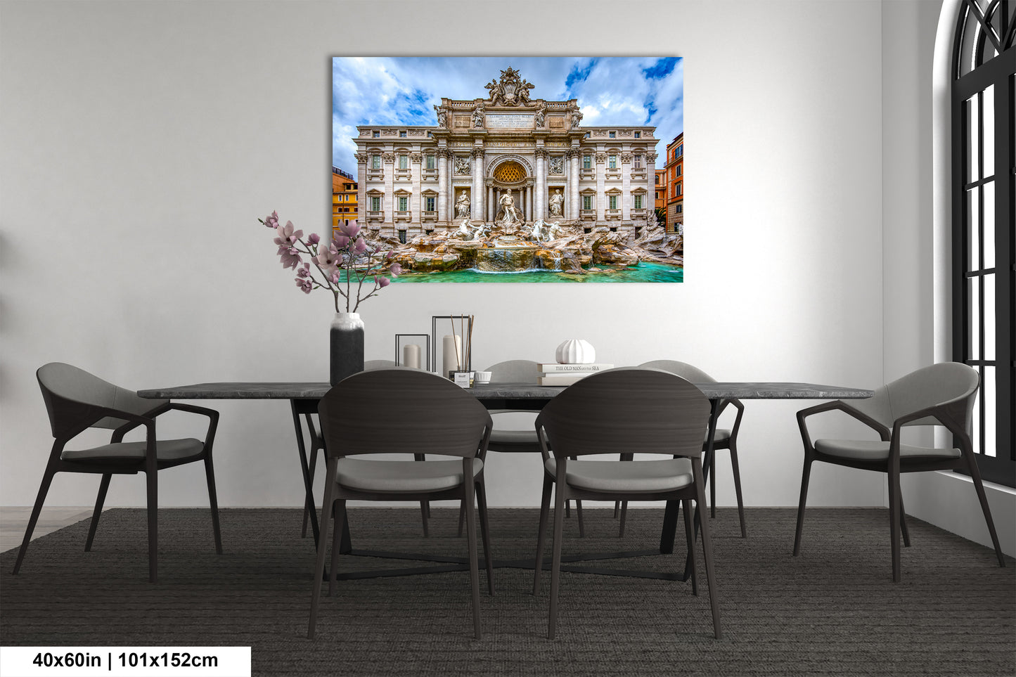 a dining room table with chairs and a painting on the wall