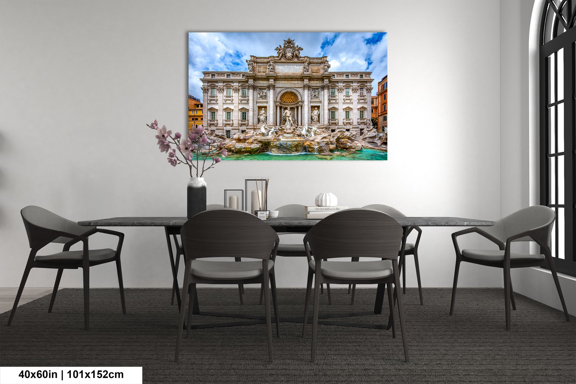 a dining room table with chairs and a painting on the wall