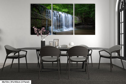 a dining room table with four chairs and a waterfall in the background