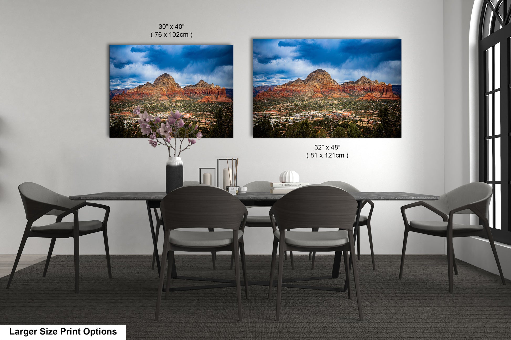 a dining room table with four chairs and a vase of flowers
