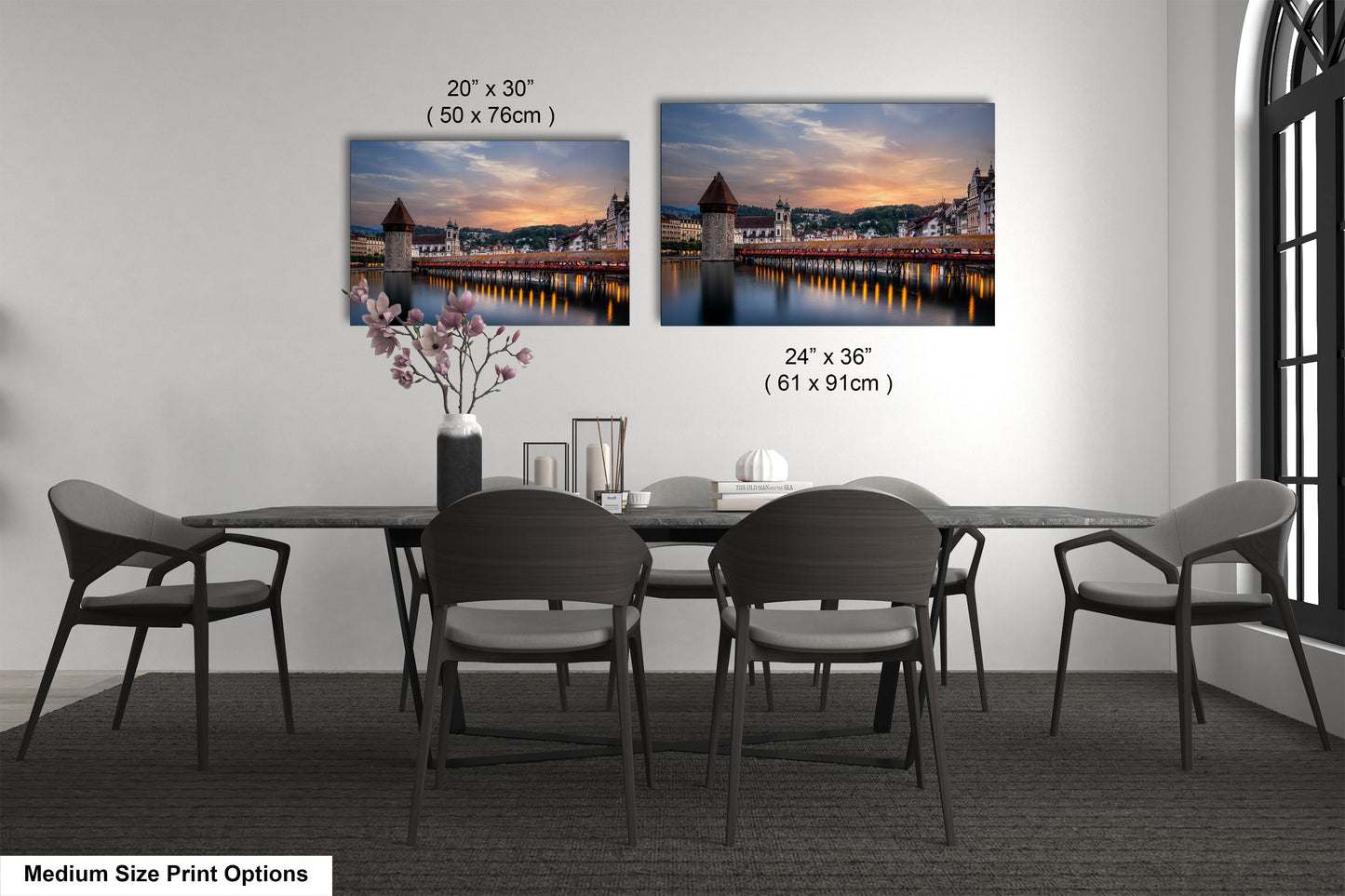 a dining table with four chairs and a vase of flowers