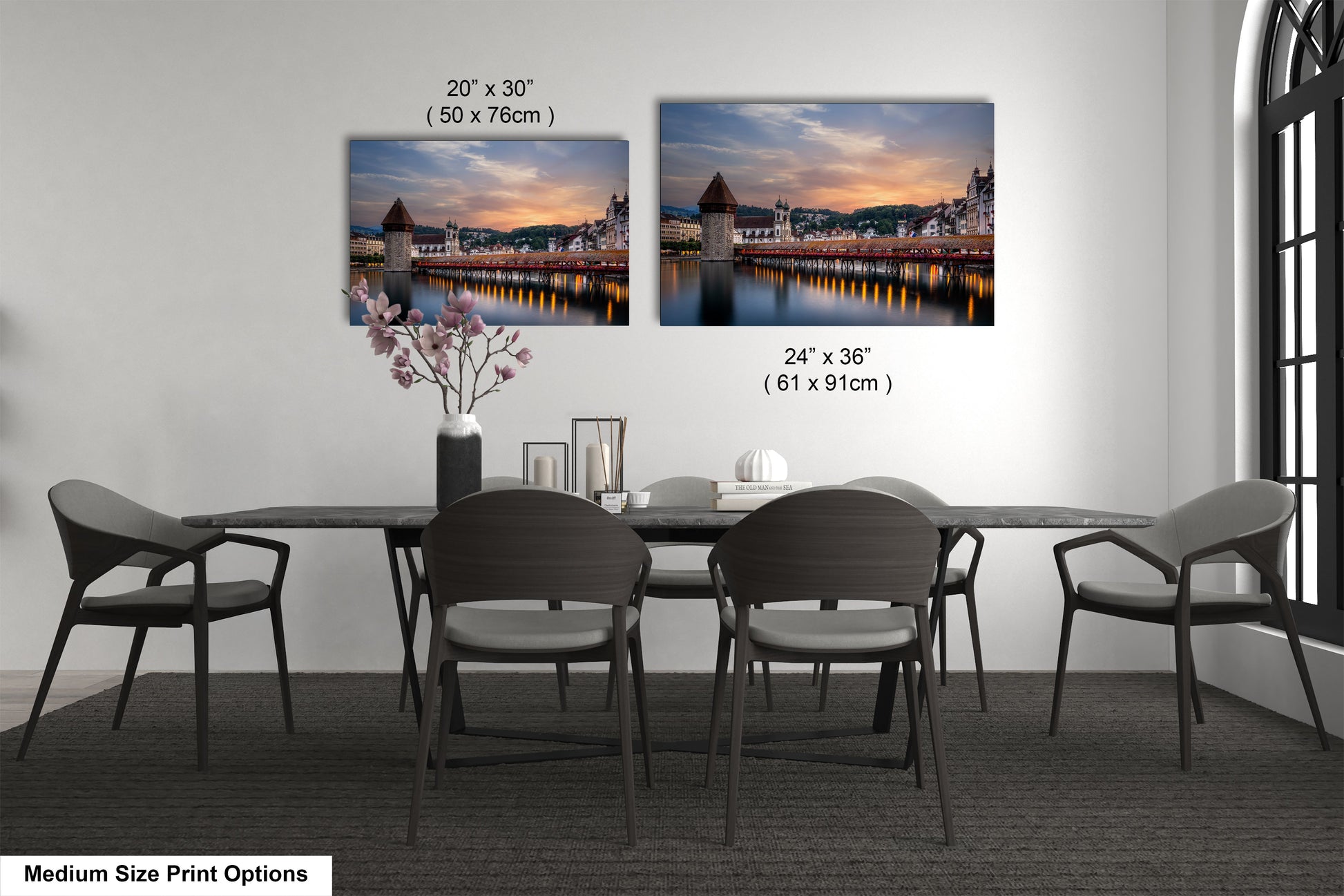 a dining table with four chairs and a vase of flowers