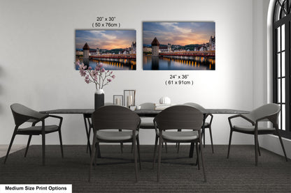 a dining table with four chairs and a vase of flowers