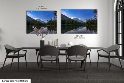 a dining table with four chairs and a vase of flowers