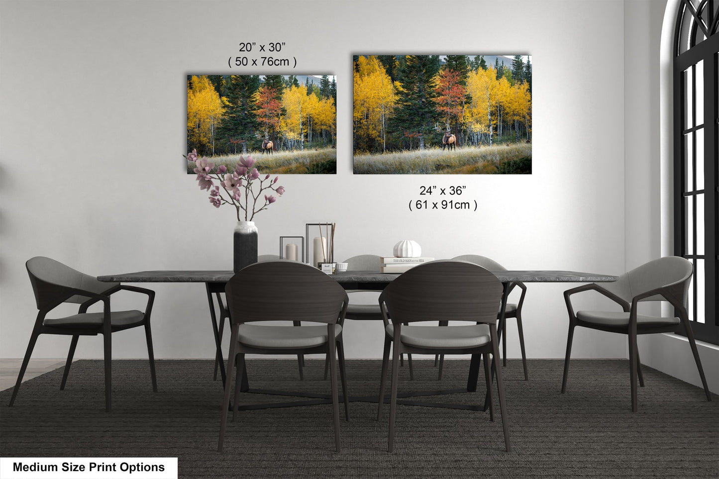 a dining table with four chairs and a vase of flowers