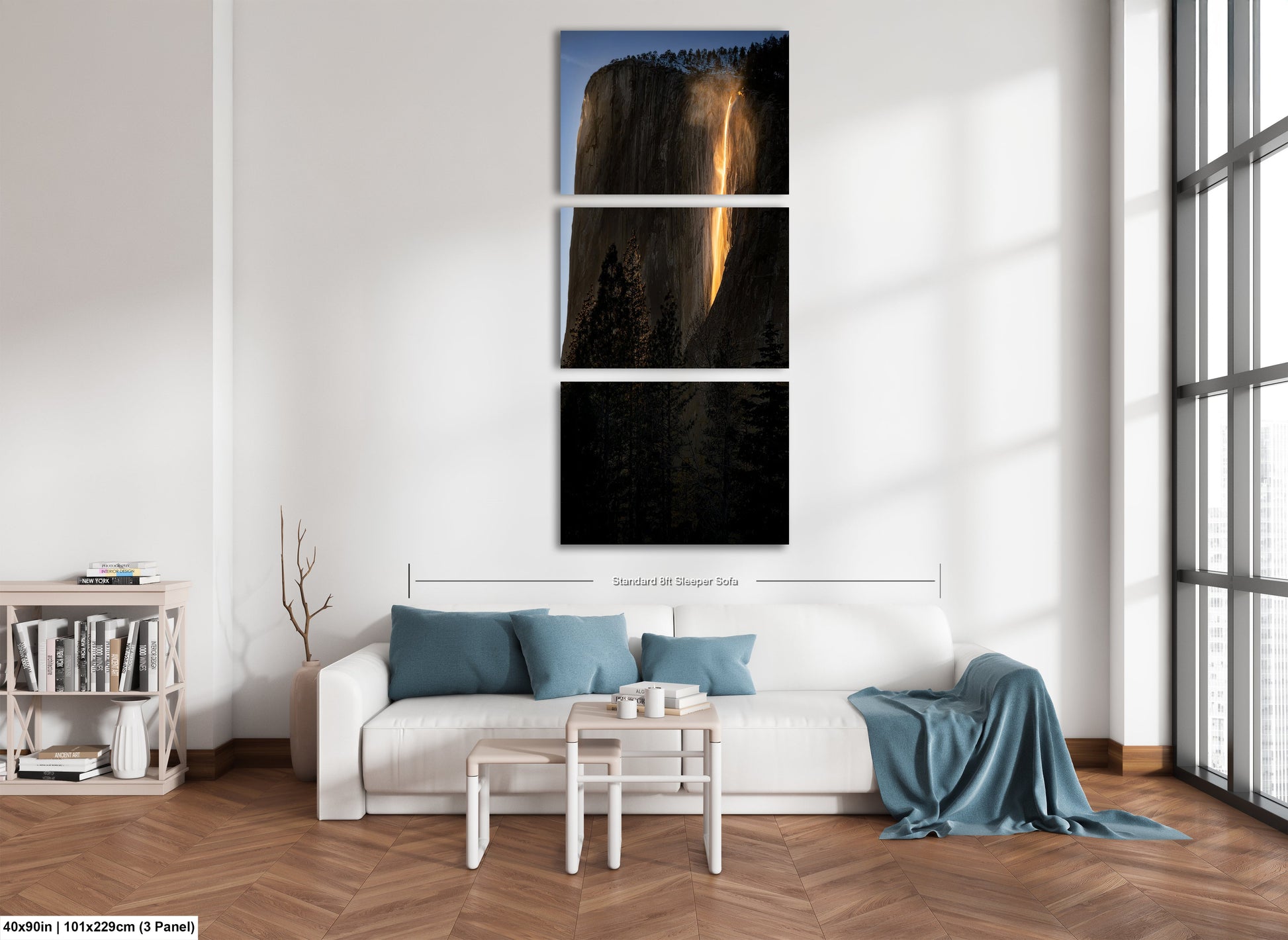 a living room with a white couch and three pictures on the wall