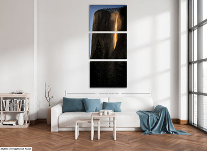 a living room with a white couch and three pictures on the wall