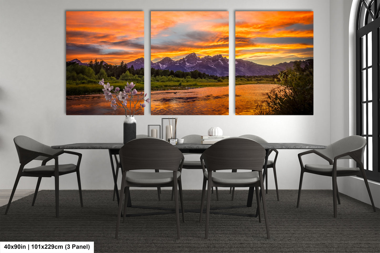 a dining room table with four chairs and a painting on the wall