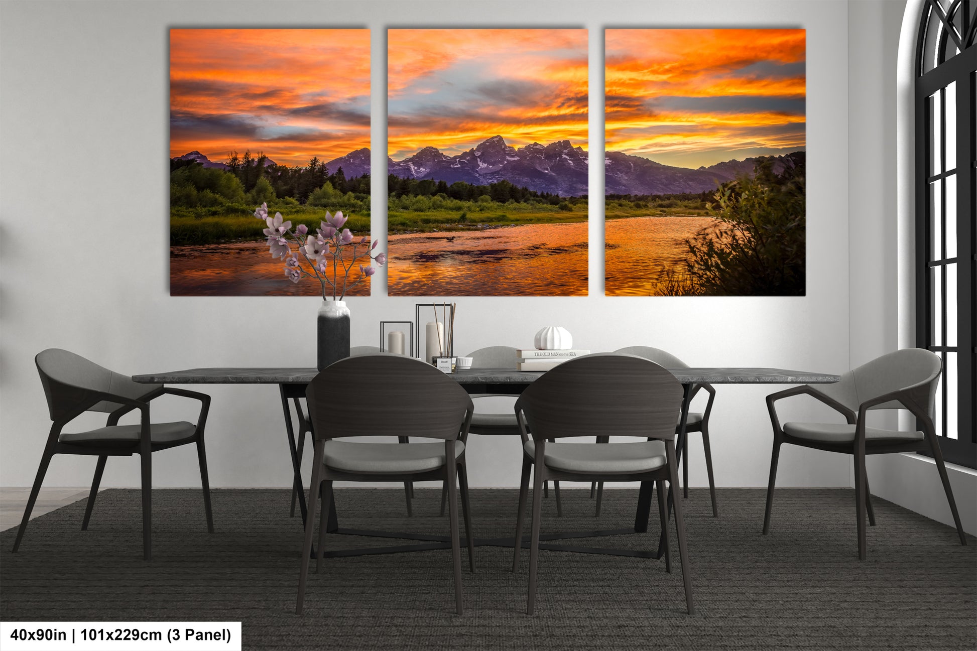 a dining room table with four chairs and a painting on the wall