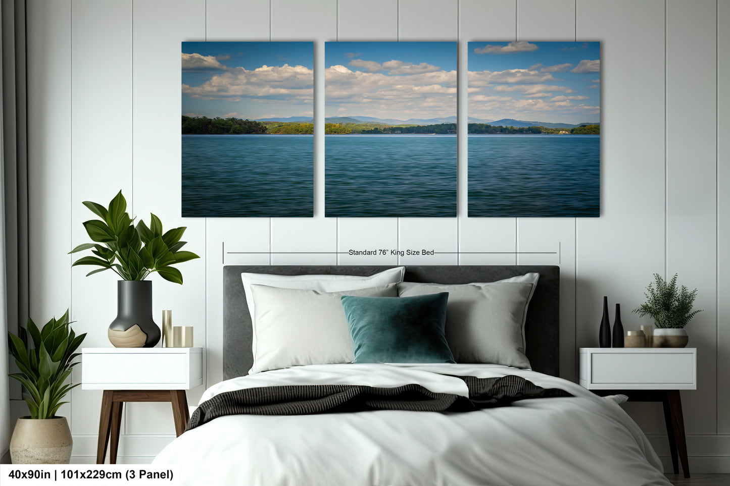 The image is a bedroom with a large, three-panel landscape painting hanging on the wall above the bed. The painting depicts a serene lake surrounded by mountains and trees. The room is decorated with potted plants, a vase, and other furnishings, creating a cozy and inviting atmosphere.