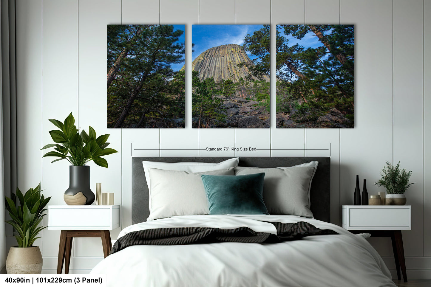 a bedroom with a bed and two paintings on the wall