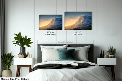 a bedroom with a bed and two pictures on the wall